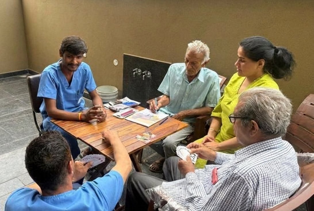 Residents engaged in an activity with a caregiver at The Vintage Assisted Living